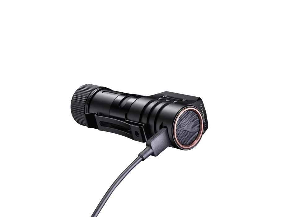 The Fenix HM71R, an ideal tactical flashlight for industrial applications, features a charging cable connected to its side and is showcased against a black background.