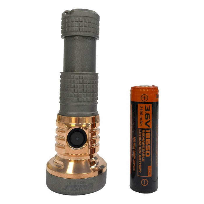 A Manker MC13 II Pocket EDC Flashlight - Titanium & Copper stands upright next to a 3.6V 18650 lithium-ion battery, showcasing its durable Titanium & Copper construction.