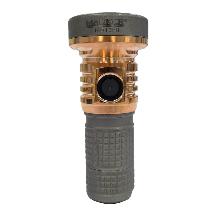 A rugged, grey, and copper Manker MC13 II Pocket EDC Flashlight - Titanium & Copper with a textured grip and a single control button on the side.