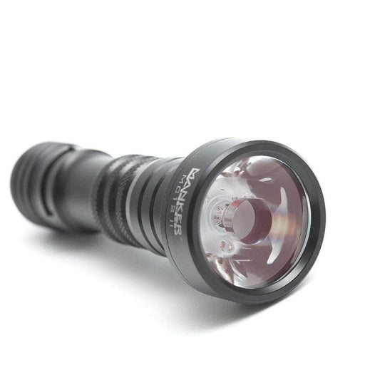 A black Mankerlight MC12 II Hunter Flashlight with a clear lens is shown lying on its side on a white background, featuring USB Type-C charging and a rechargeable lithium-ion battery.