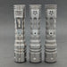 Three ReyLight LANapple - Ti flashlights with decorative vent holes are standing upright on a gray surface. These silver titanium flashlights feature ridged bodies, sturdy clips for attachment, and are compatible with rechargeable 14500 batteries.