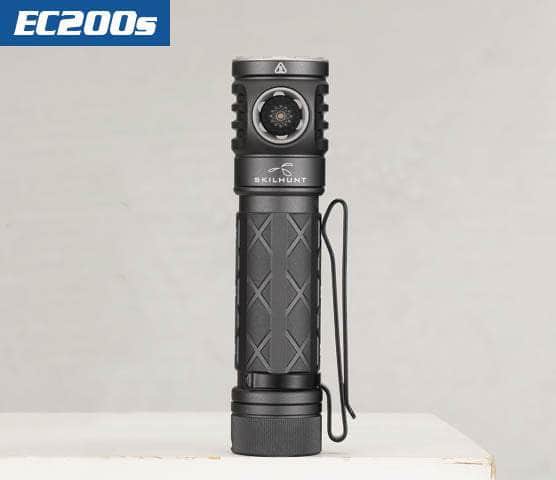 A black Skilhunt EC200S, boasting 2100 lumens, stands upright on a white surface against a plain background. It features a textured grip and a convenient side button, with the added benefit of being USB-C rechargeable.