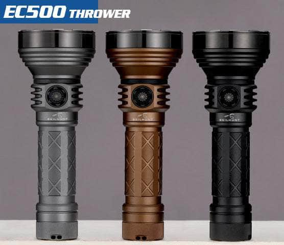 Three Skilhunt EC500 flashlights in gray, brown, and black are displayed upright on a neutral background, with "EC500 Thrower" text at the top left. These USB-C rechargeable, long-range flashlights boast an impressive 2100 lumens, making them perfect for any adventure.