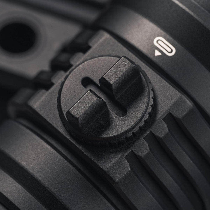 Close-up of the locking mechanism on a Weltool F11R flashlight, showing a textured knob and a lock symbol with an arrow. The detail highlights precision in design and engineering, much like the efficient USB-C charging structure seen in advanced devices.