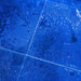 Blue tiles with scattered white residue and faint imprints on the surface reveal their hidden details when illuminated with a high-power output from the Weltool M4-365 UV flashlight.