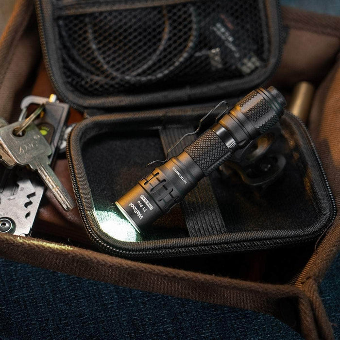 The Weltool T1 Pro V2, powered by a 14500 lithium-ion battery, rests on an unzipped black case inside a larger bag with visible car keys nearby.